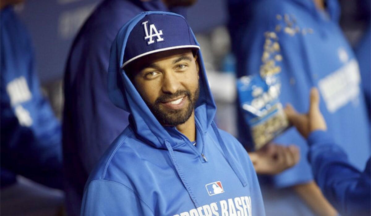 Matt Kemp smiles in the Dodgers' dugout during the second game of the Freeway Series against the Angels on Friday. Kemp says he'll be ready to go when he's eligible to be activated next week.