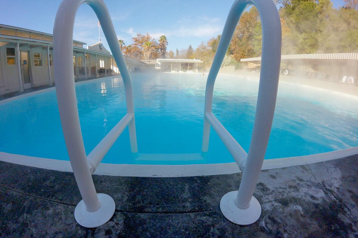 Steam rises from a pool under blue sky at Indian Springs, Calistoga.