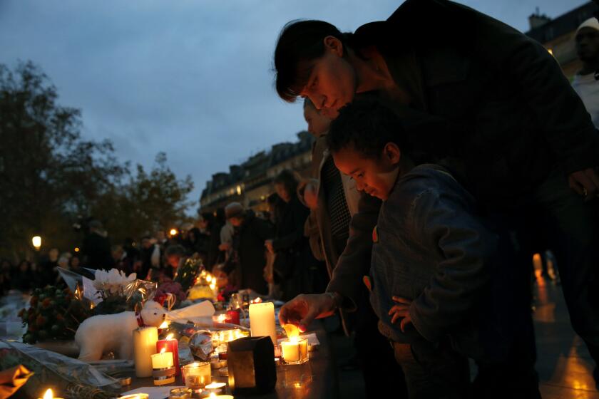 On the third day of national mourning following Friday's attacks in Paris, people continue to gather in the city's public places such as the Place de la Republique, including Tao Cisse, age 5, and Maya Sutej.
