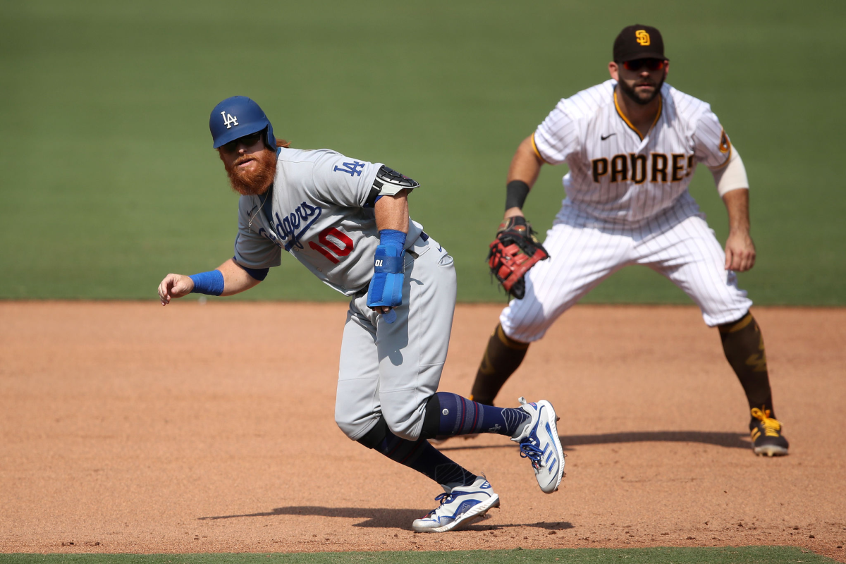 Justin Turner gets a leadoff jump at first base for the Dodgers in front of San Diego’s Mitch Moreland.