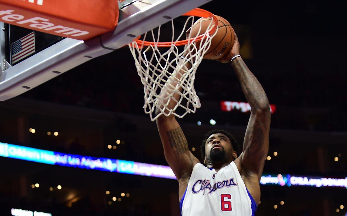 Clippers center DeAndre Jordan goes up for a slam dunk against the Timberwolves.