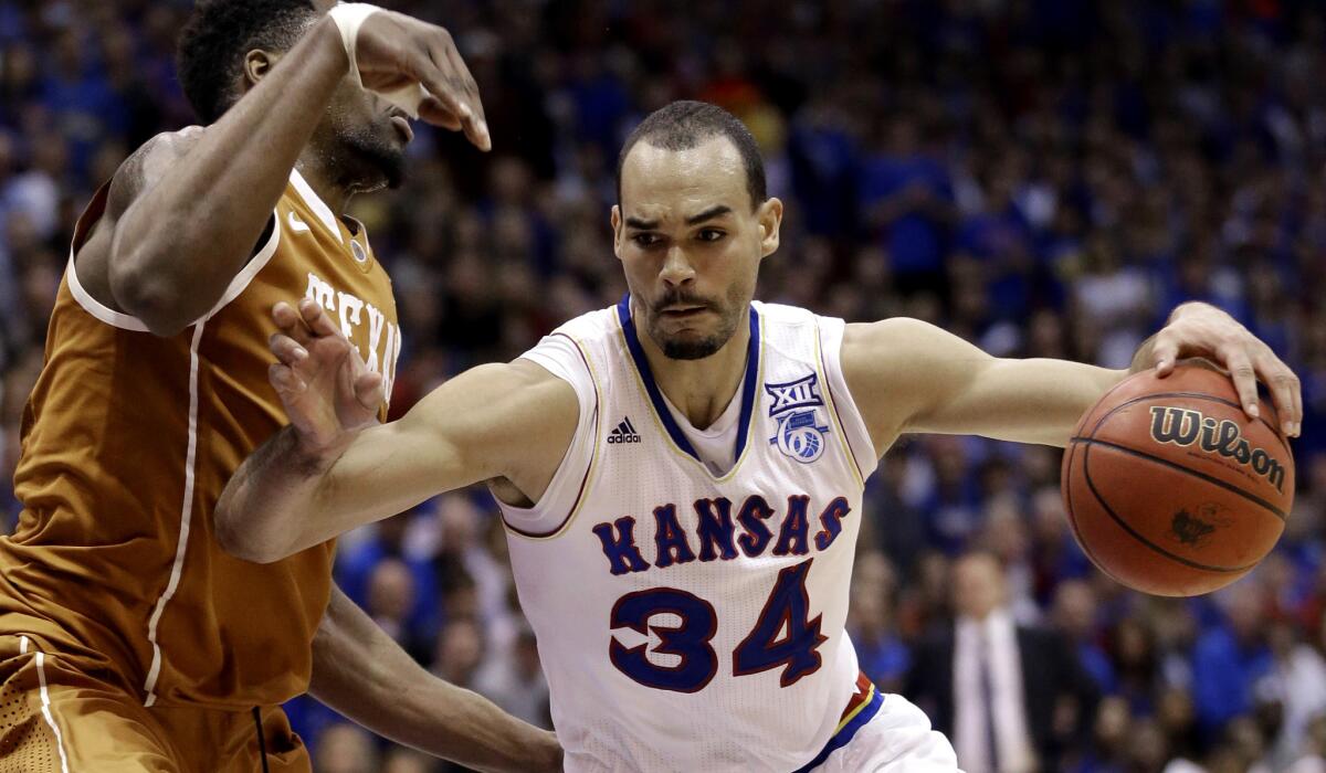 Kansas forward Perry Ellis, who just returned from injury, drives against Texas center Prince Ibeh during a game earlier this season.