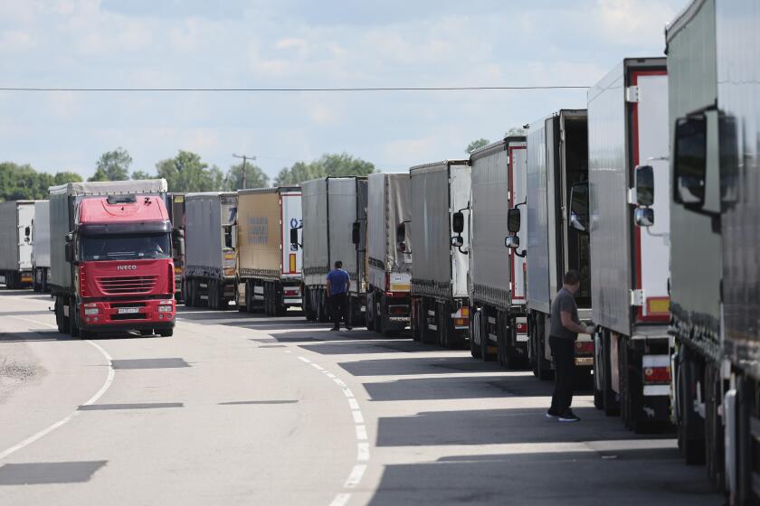 FILE - Trucks stands at the post-customs international checkpoint Chernyshevskoye at the Russian-Lithuanian border in Kaliningrad region, Russia, Wednesday, June 22, 2022. The Baltic states of Estonia, Latvia and Lithuania have in a jointly coordinated move banned vehicles with Russian license plates from entering their territory as part of the European Union’s recent new interpretation of sanctions against Moscow. (AP Photo, File)