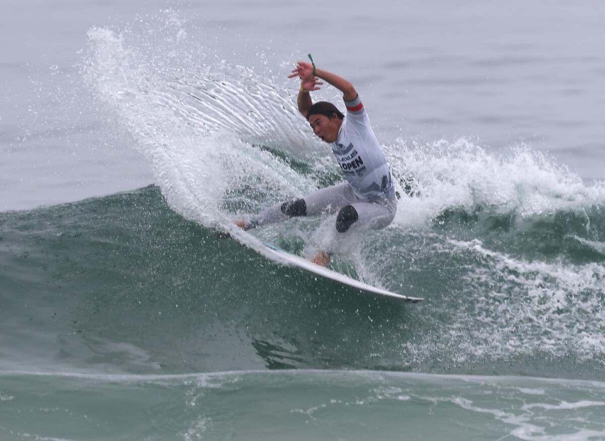 Tenshi Iwami of Japan surfs to first in his heat during the round of 80 of the U.S. Open of Surfing on Thursday.