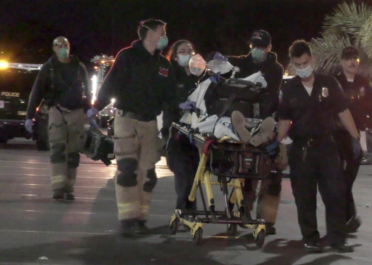 Emergency personnel transport a person in Riverside County on a gurney.