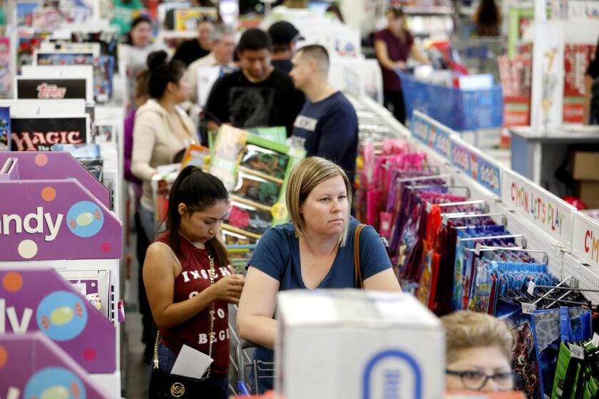 Black Friday shoppers wait to check out at a Toys R Us store in Ontario.