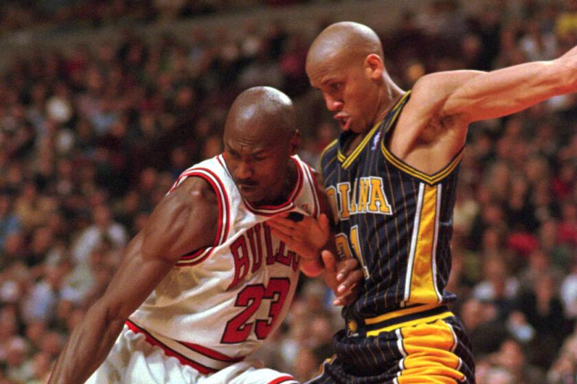 Chicago Bulls' Michael Jordan (23) loses control of the ball while being guarded by Indiana Pacers' Reggie Miller (31) during the second half Tuesday, Feb. 17, 1998, in Chicago. The Bulls defeated the Pacers 105–97. (AP Photo/Fred Jewell)