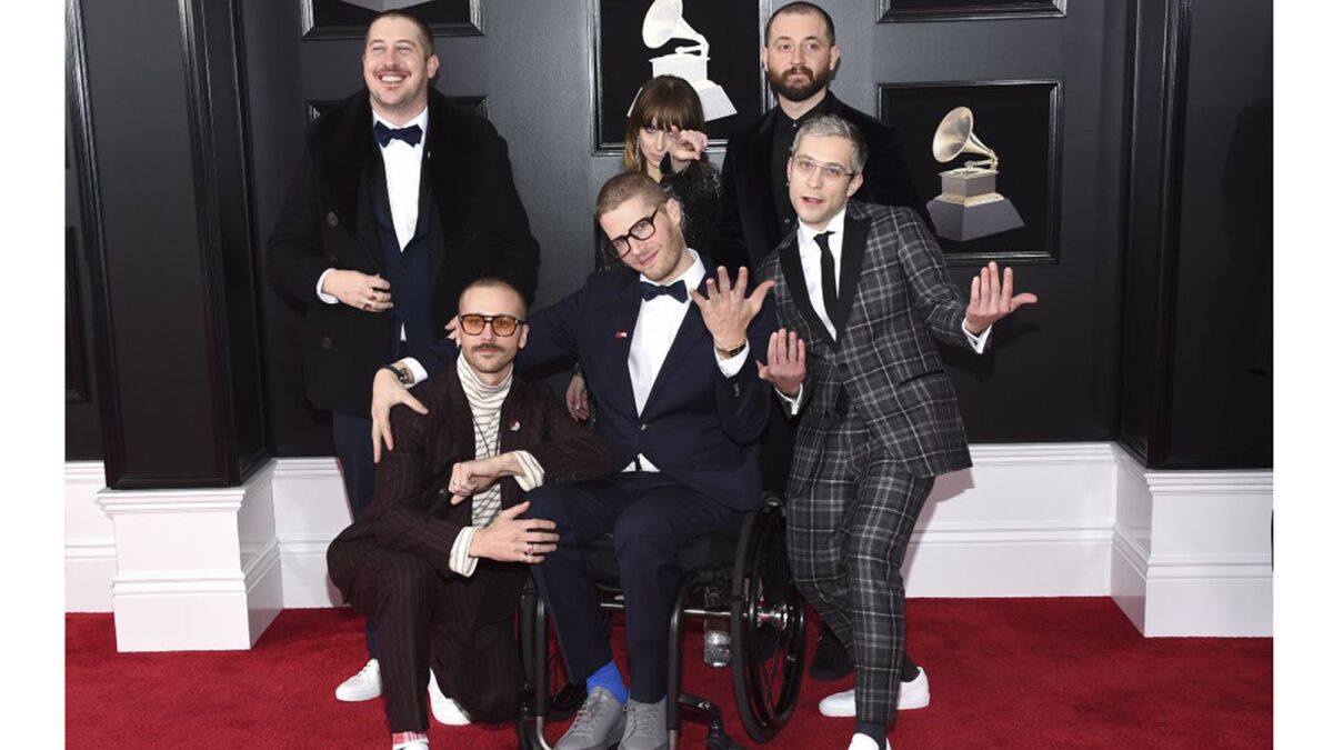 The members of Portugal. The Man strike a pose at the 20118 Grammy Awards in New York. From left are Zach Carothers, John Gourley, Eric Howk, Zoe Manville, Jason Sechrist and Kyle O'Quin.