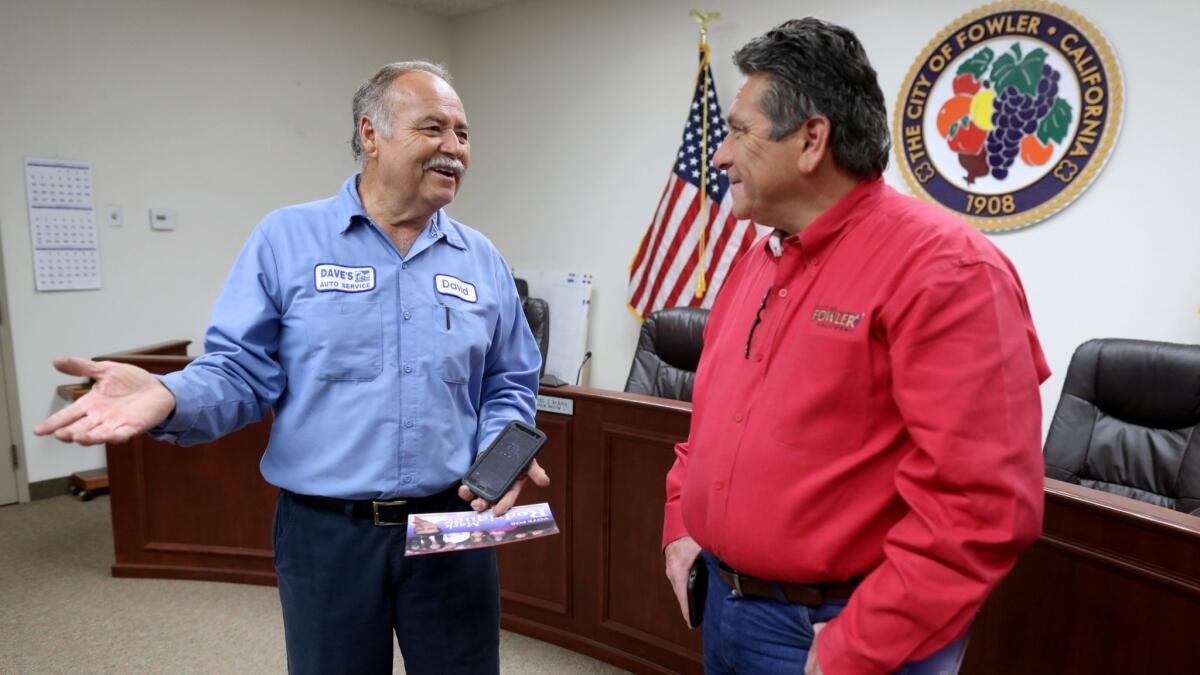 David Cardenas, mayor of Fowler, discusses the upcoming city elections with council member Mark Rodriquez in the council chambers in Fowler.