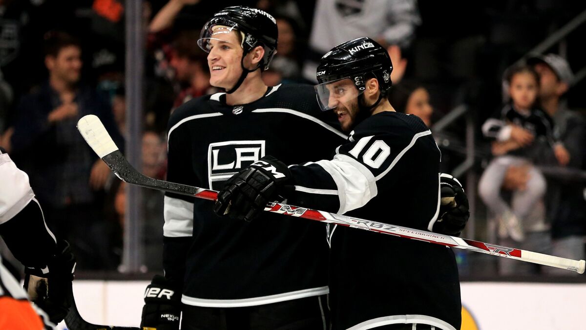 Kings defenseman Daniel Brickley, left, and teammate Tobias Rieder celebrate after Brickley earned his first NHL point (with an assist on Rieder's goal) during the second period against the Wild on Thursday.