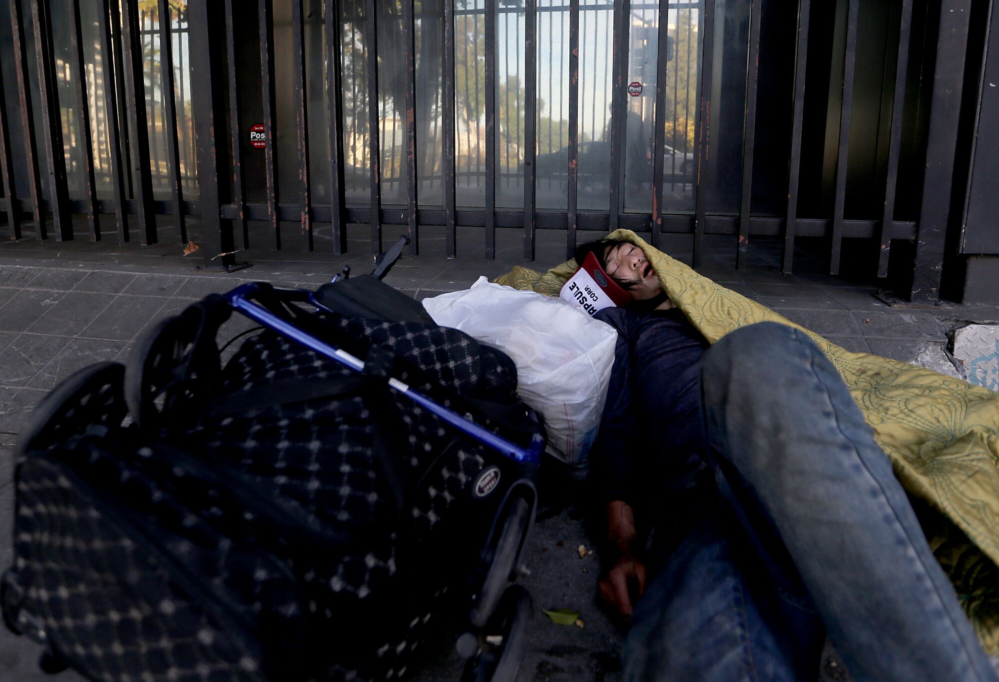  A homeless man sleeps on the street in downtown Los Angeles