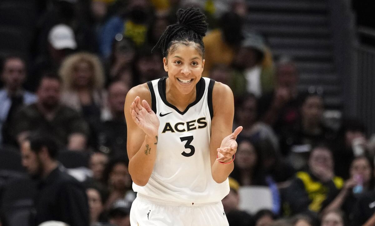 Aces forward Candace Parker claps her hands as she reacts to a play.