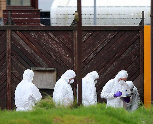 Police forensic team at a British army base in Northern Ireland