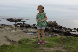 This photo of a four-year-old girl, taken last year on a beach in Zushi, Japan, has people asking what is that is behind her?