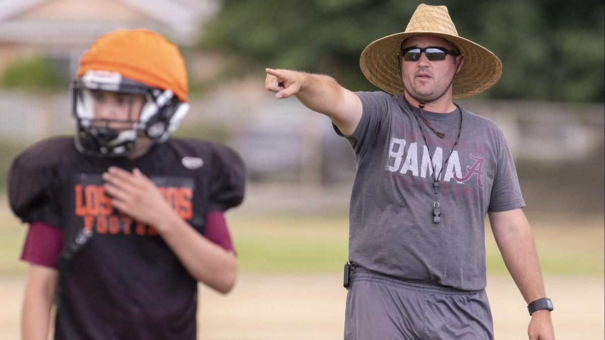 Los Amigos High coach Carl Agnew, shown during practice on Aug. 10, will try to stop his team's three-game losing streak when the Lobos play Loara on Friday at Garden Grove High.