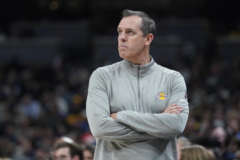 Los Angeles Lakers head coach Frank Vogel watches during the second half of an NBA basketball game.