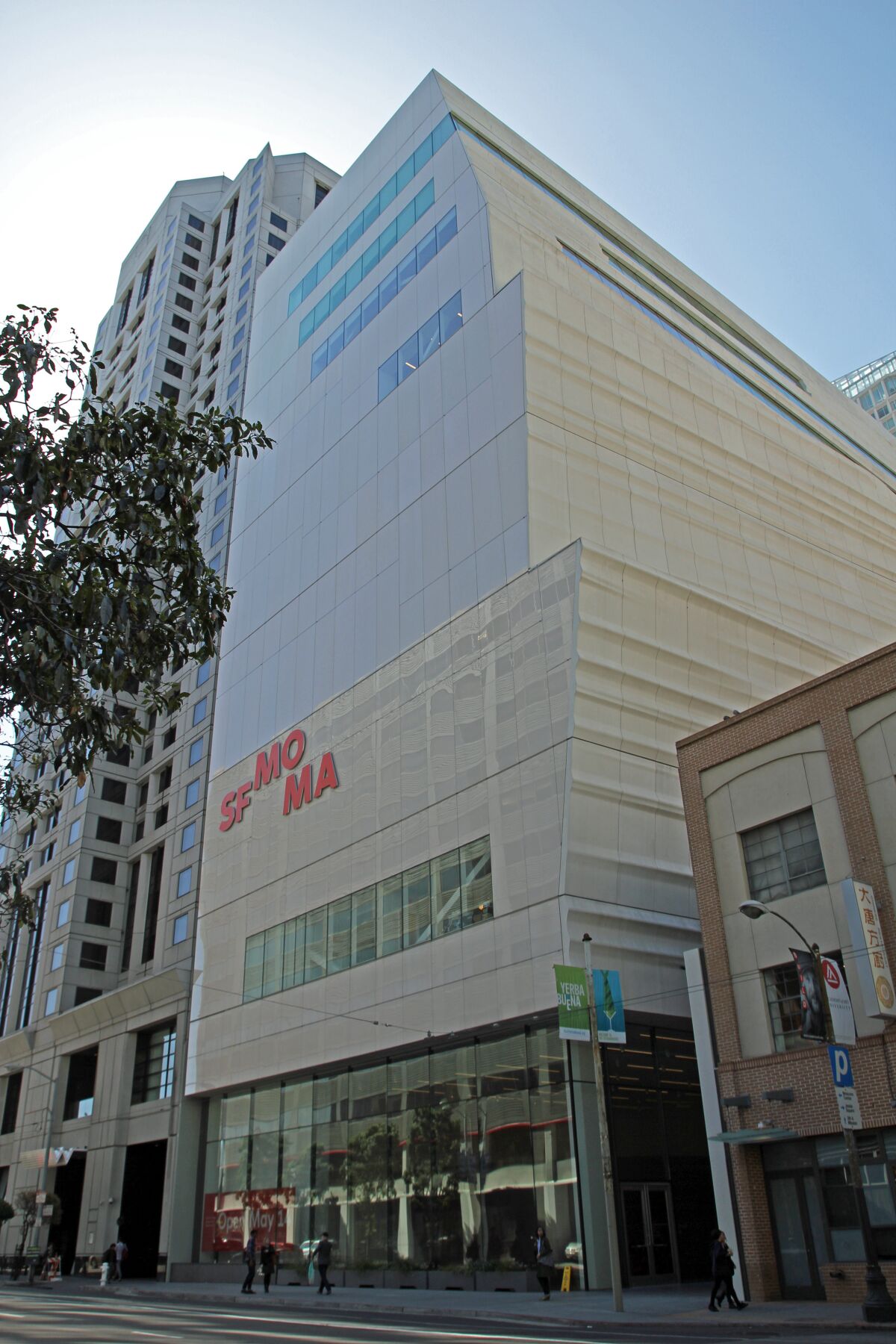 SFMOMA's white-paneled facade is seen from a San Francisco street.