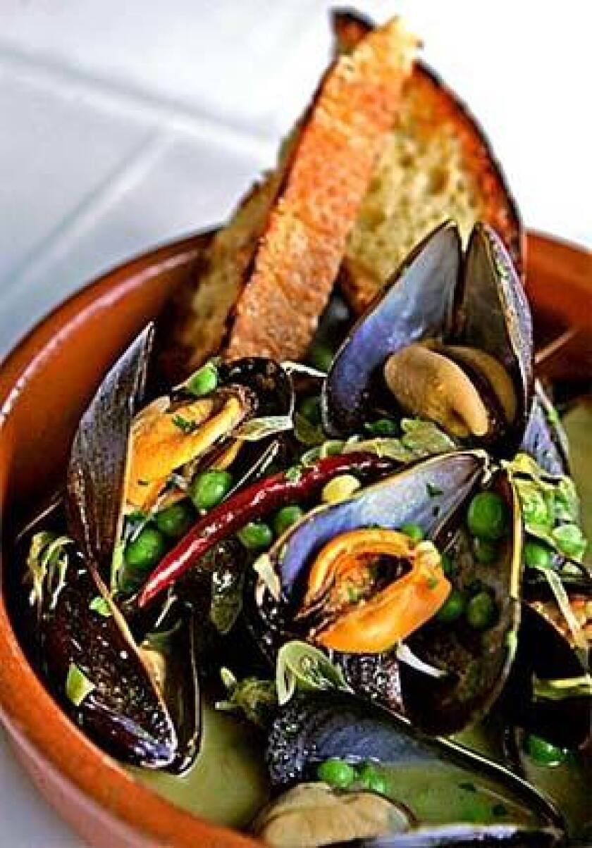 Mussels in white wine with new garlic and English peas.