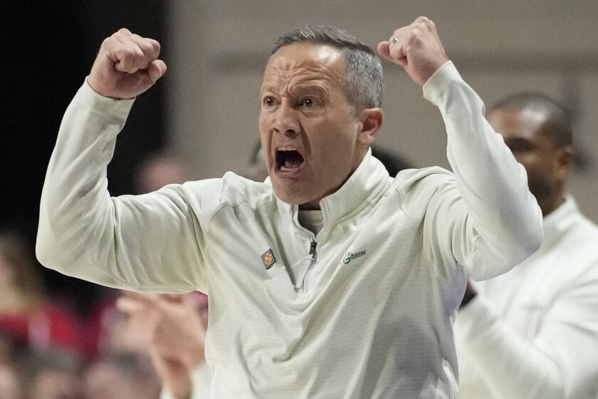 North Texas head coach Grant McCasland motions to his players during the second half of an NCAA college basketball game against Wisconsin in the semifinals of the NIT, Tuesday, March 28, 2023, in Las Vegas. (AP Photo/John Locher)