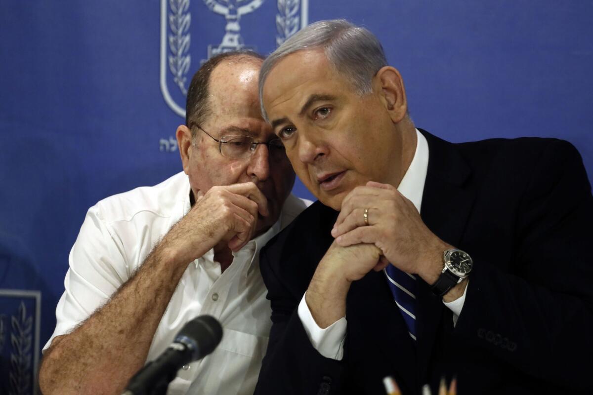 Israeli Defense Minister Moshe Yaalon, left, and Prime Minister Benjamin Netanyahu last month. Yaalon told reporters Sept. 16 that there were "no signs fire from the [Gaza] Strip will resume at the end of the month."