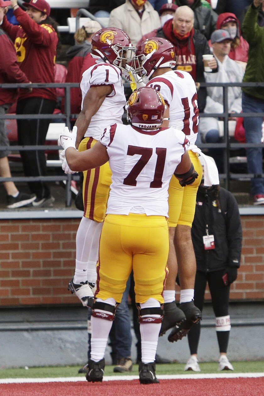 USC receiver Gary Bryant Jr. (1) celebrates his TD catch with tight end Jude Wolfe (18) and offensive lineman Liam Jimmons.