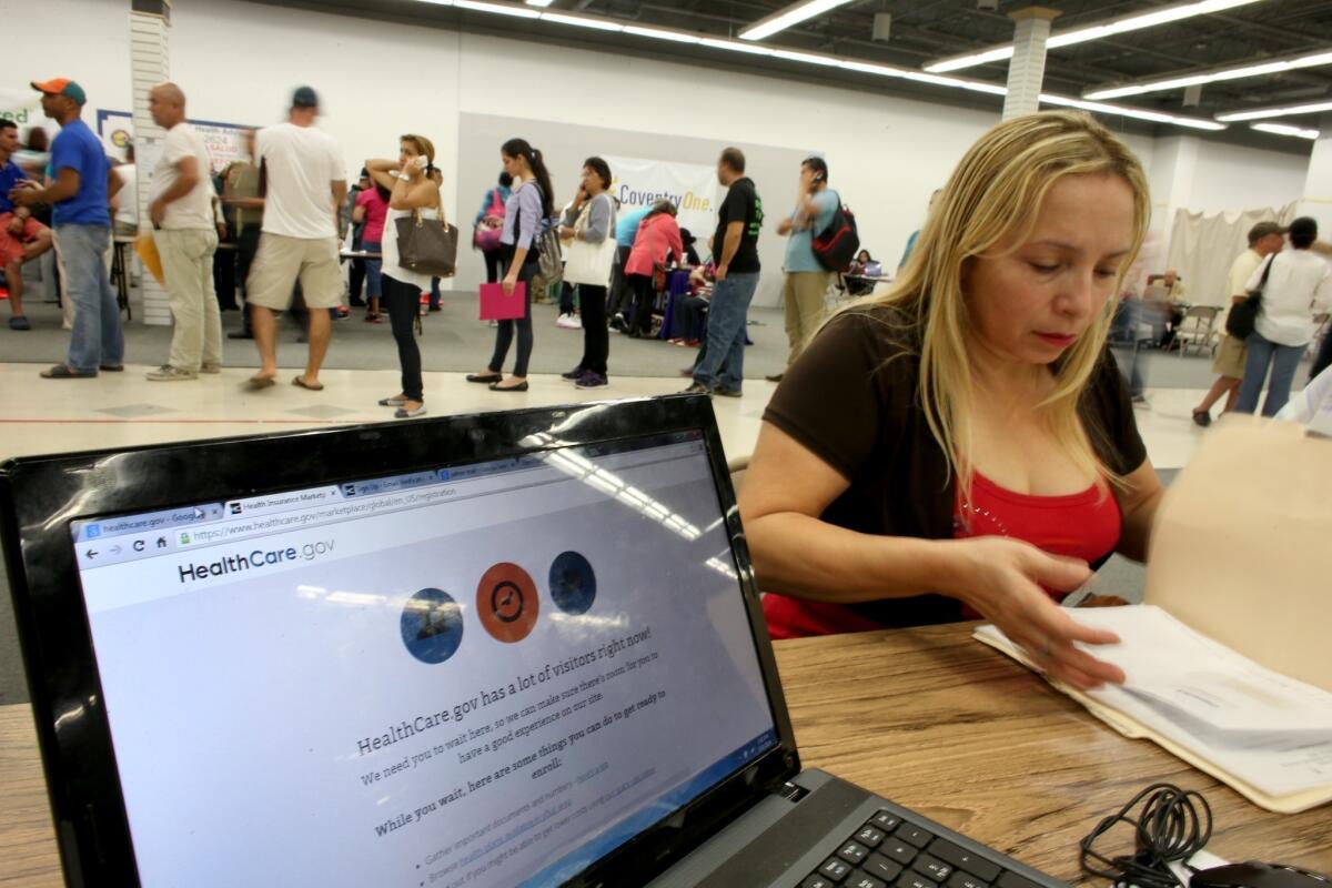 Norma Licciardello at a store set up in Miami's Mall of Americas waits to sign up for health insurance on March 31, the final day of open enrollment under Obamacare.