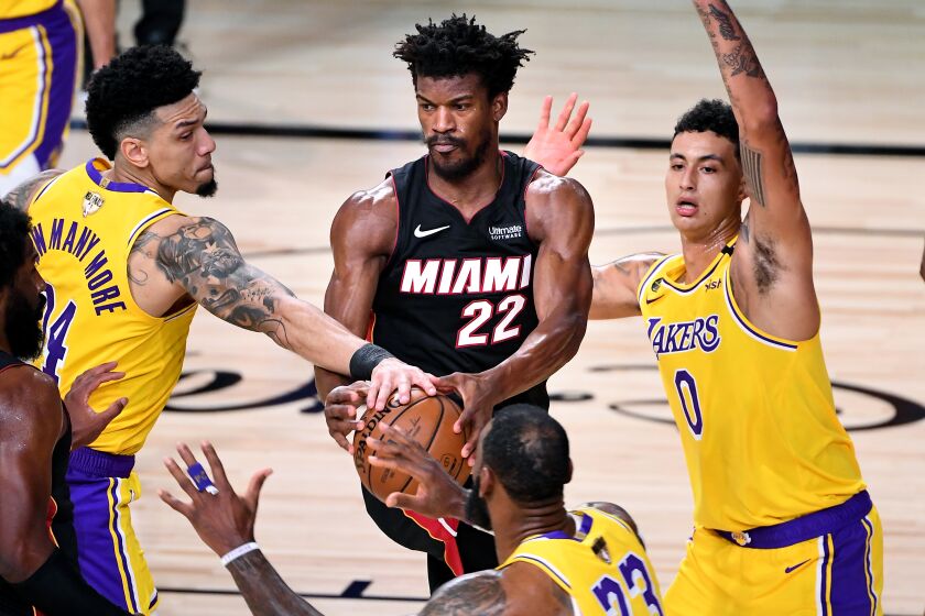 Lakers guard Danny Green, left, knocks the ball from Heat forward Jimmy Butler during Game 1.