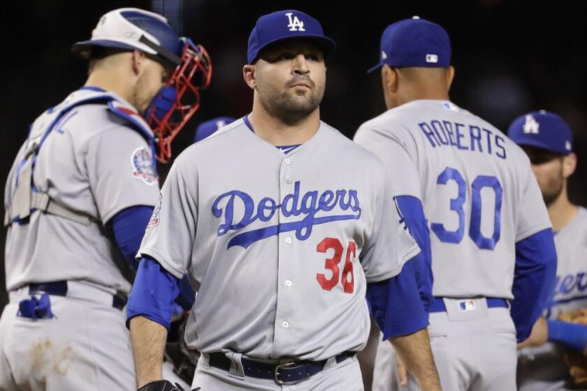 Los Angeles Dodgers relief pitcher Adam Liberatore (36) is pulled form the game by manager Dave Roberts (30) after giving up a two run triple against the Arizona Diamondbacks during the seventh inning of a baseball game Tuesday, May 1, 2018, in Phoenix. (AP Photo/Matt York)