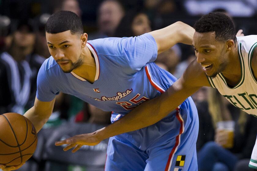 Clippers guard Austin Rivers, left, drives ahead of Boston Celtics small forward Evan Turner during a Clippers win on March 29.