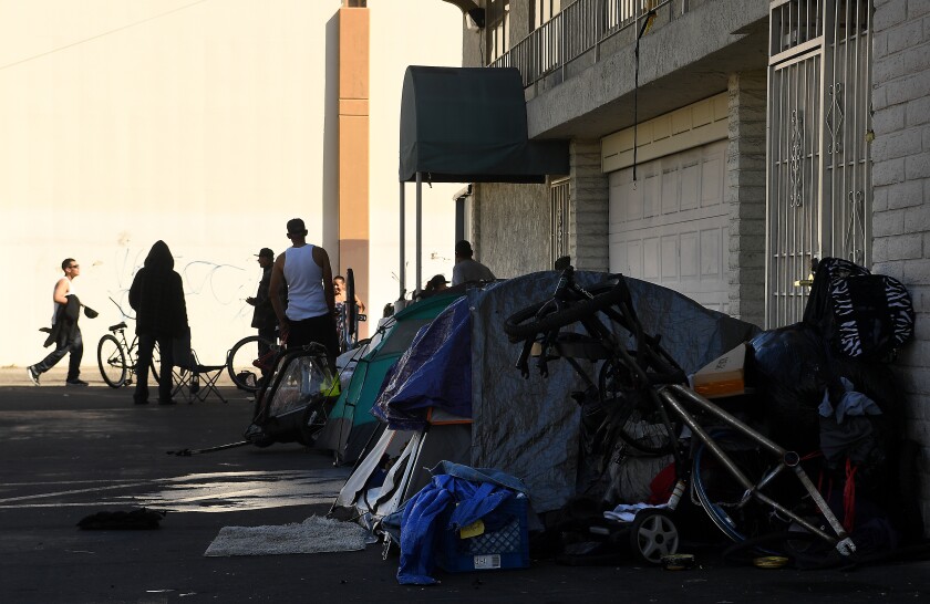 Homeless people live outside a cultural center in Santa Ana.