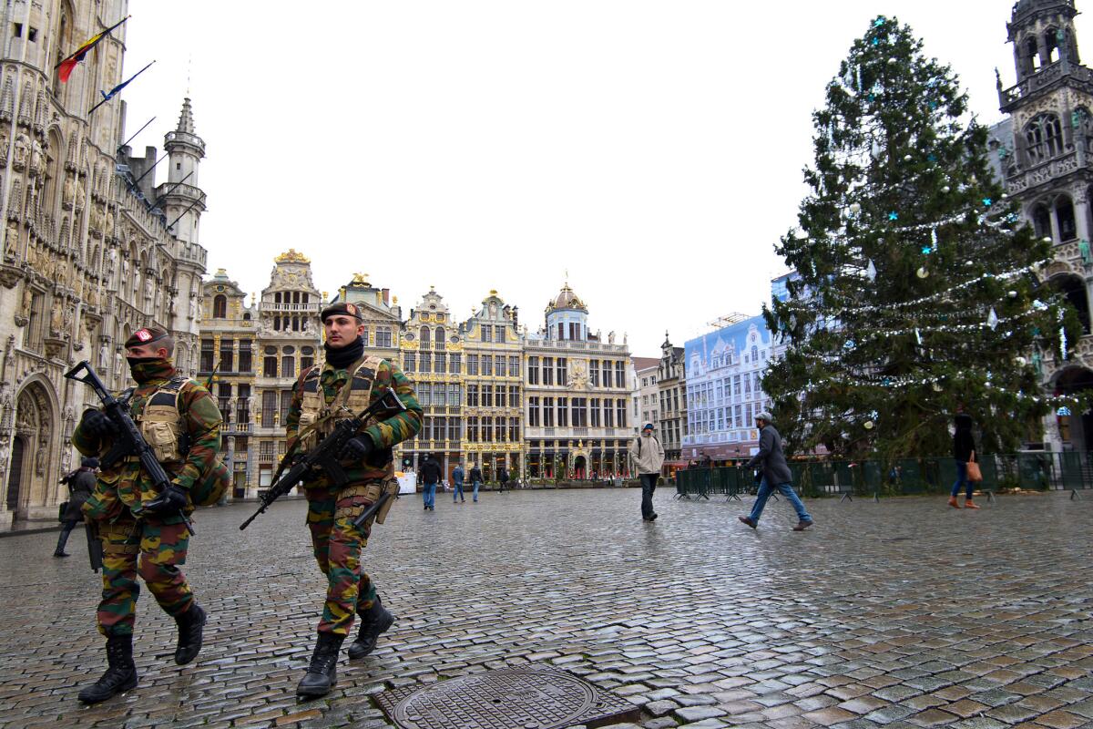 Armed soldiers patrol Tuesday in Brussels.