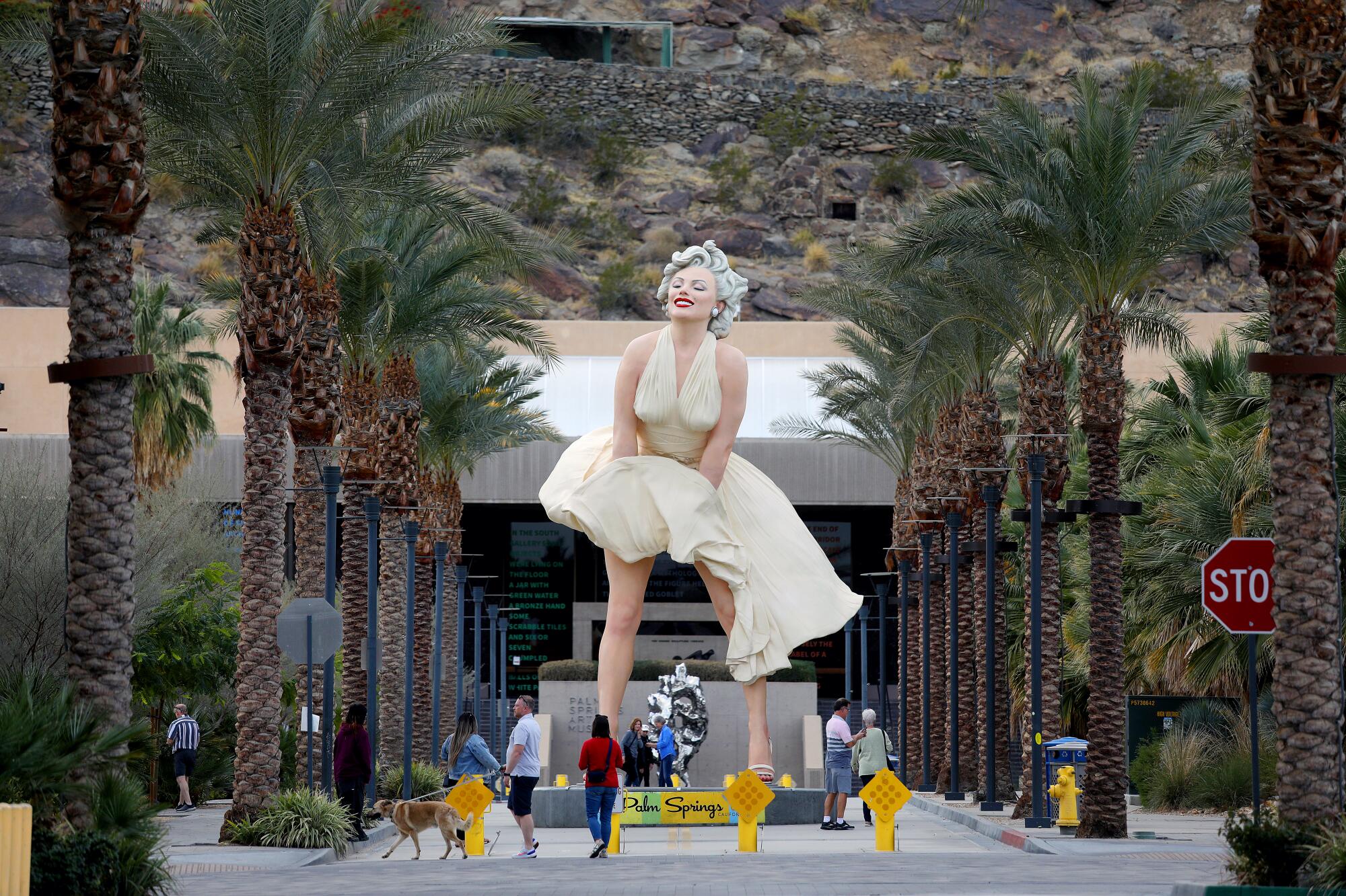 People walk by the giant 'Forever Marilyn' sculpture in downtown Palm Springs.