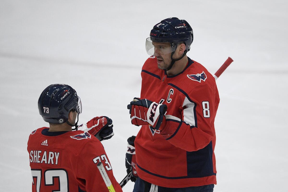 Washington Capitals left wing Alex Ovechkin (8) celebrates his goal with left wing Conor Sheary (73) during the third period of an NHL hockey game against the Philadelphia Flyers, Tuesday, April 13, 2021, in Washington. The Capitals won 6-1. (AP Photo/Nick Wass)