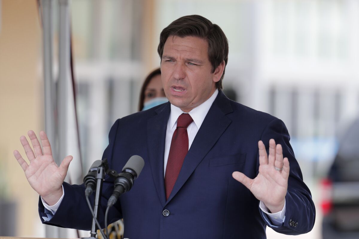 Florida Gov. Ron DeSantis speaks outside at a May news conference.