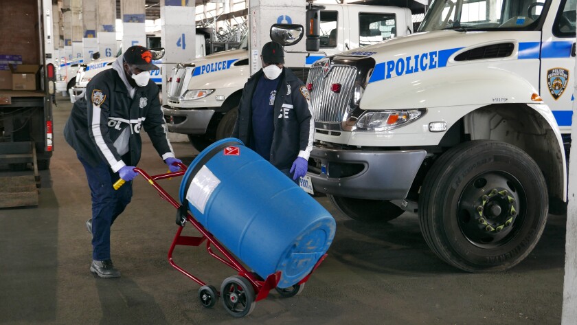 NYPD Det. Dwayne Francis and Officer Donald Vale deliver hand sanitizer to a command in Long Island City, N.Y.