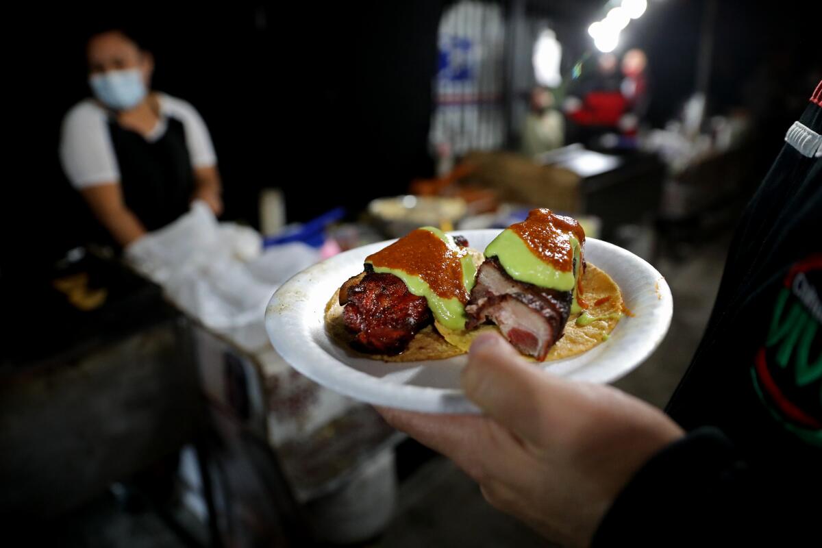 Gilbert Valdez, of East Los Angeles, with an order of pork rib tacos at Tacos a Cabron