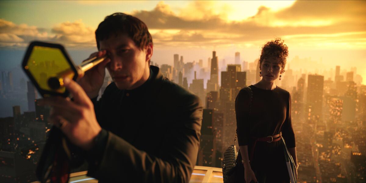 A man on the roof of a skyscraper looks through a spyglass as a woman watches from behind him.