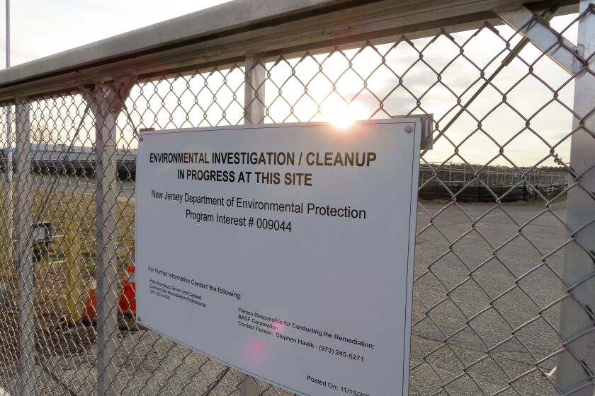 A gate at the entrance to the former Ciba Geigy chemical plant in Toms River, N.J., displays a warning sign Tuesday, Jan. 24, 2023, regarding the contaminated area, which is on the Superfund list of the nation's worst toxic waste sites. A proposed settlement to restore natural resources damaged by the company's dumping is widely opposed as insufficient by residents of Toms River, where childhood cancer rates from the late 1970s through 1990s occurred at elevated rates. (AP Photo/Wayne Parry)
