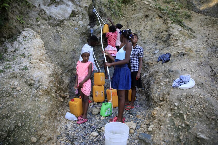 People, without running water at home, collect water from a ravine in Port-au-Prince, Haiti, March 21, 2023. (AP Photo/Odelyn Joseph)