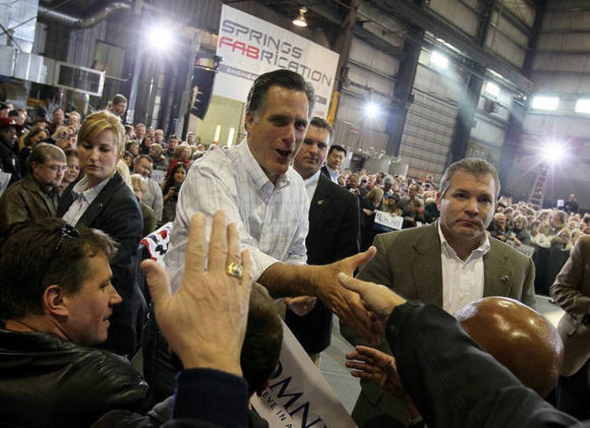 Mitt Romney greets supporters during a campaign rally Saturday at Colorado Springs Fabrication in Colorado Springs, Colo.