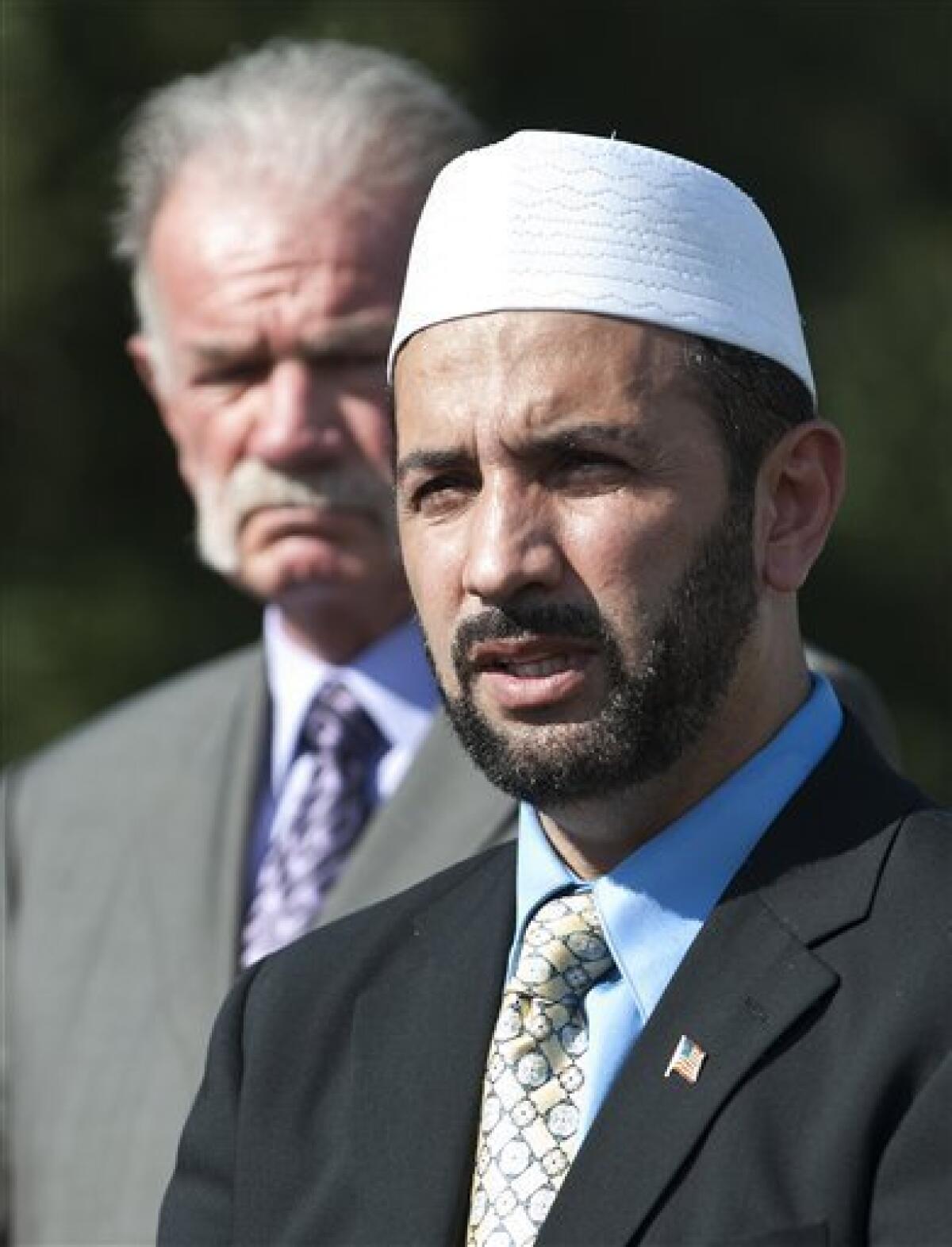 Imam Muhammad Musri of the Islamic Society of Central Florida, right, speaks to the media as Pastor Terry Jones of the Dove World Outreach Center looks, Thursday, Sept. 9, 2010, in Gainesville, Fla. (AP Photo/Phil Sandlin)