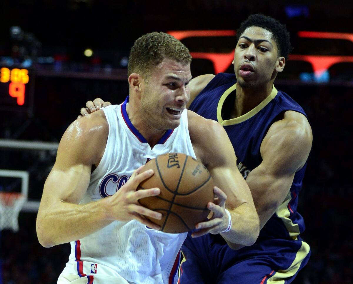 Blake Griffin, left, drives against Anthony Davis in a game between the Clippers and the New Orleans Pelicans at Staples Center in Los Angeles.