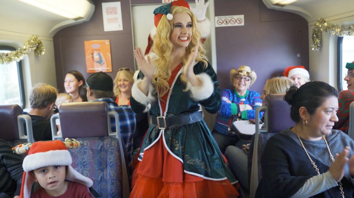 A Santa's helper entertains riders on the Metrolink's Holiday Express.
