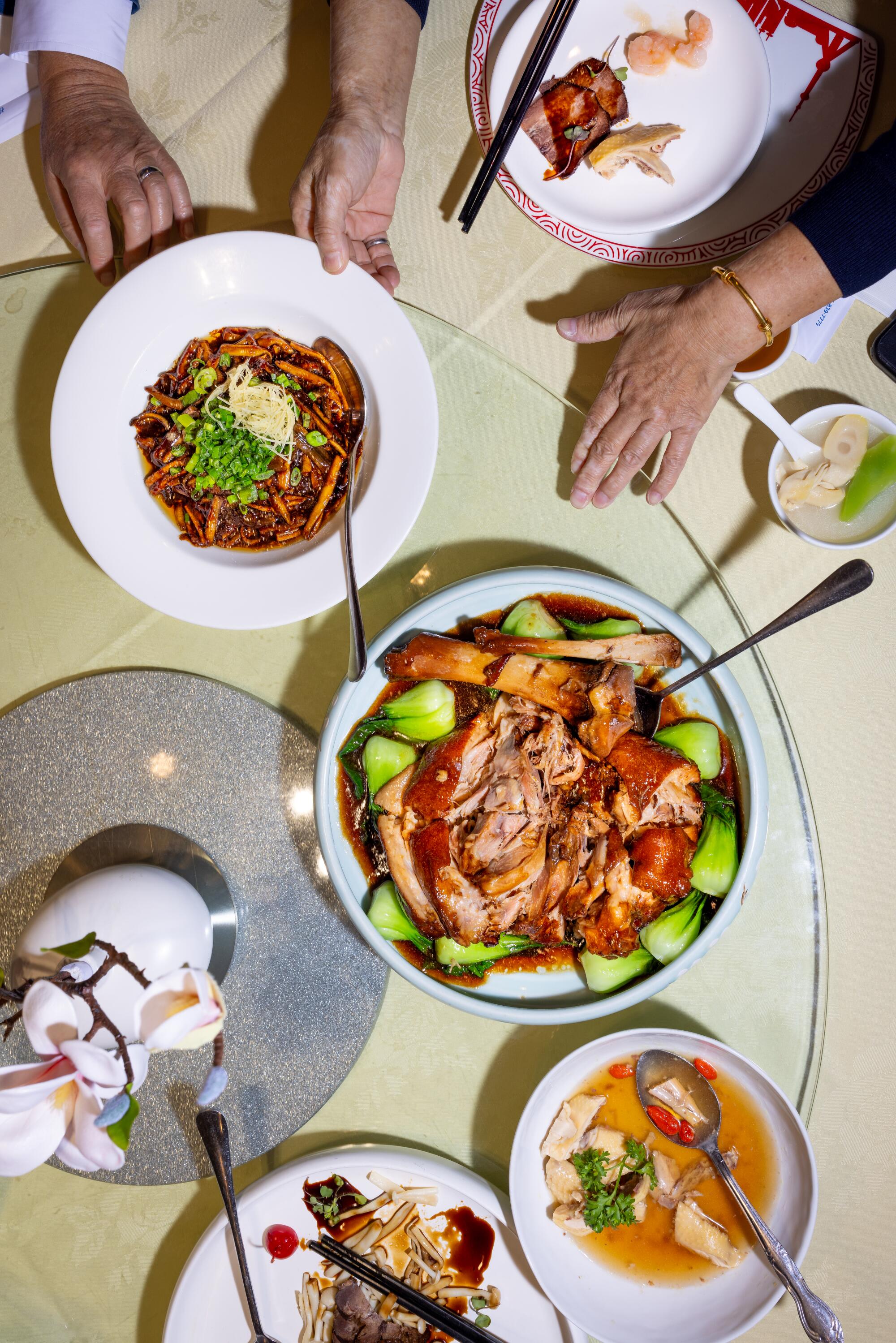 A selection of dishes including, at the center, the Shanghai trotter, and to the left, the sauteed eels. 