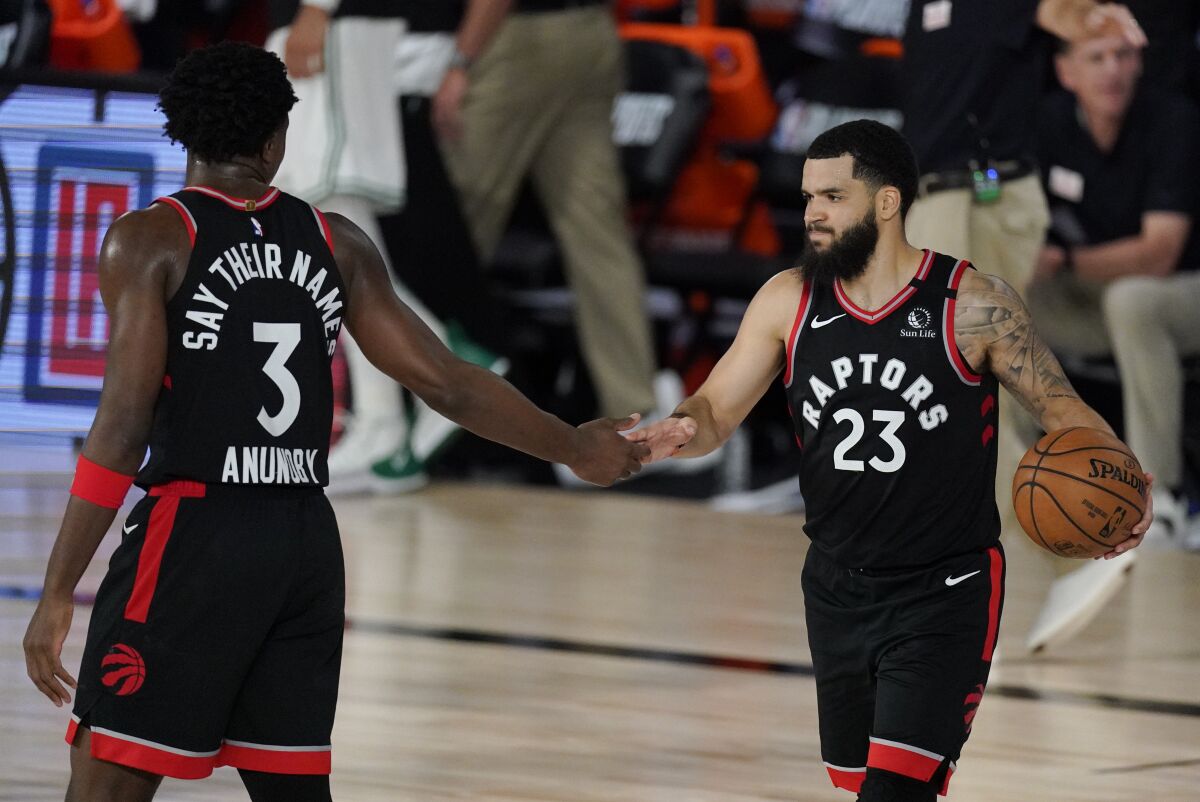 Toronto Raptors' Fred VanVleet (23) celebrates with teammate OG Anunoby (3) during the second half of an NBA conference semifinal playoff basketball game against the Boston Celtics Saturday, Sept. 5, 2020, in Lake Buena Vista, Fla. (AP Photo/Mark J. Terrill)