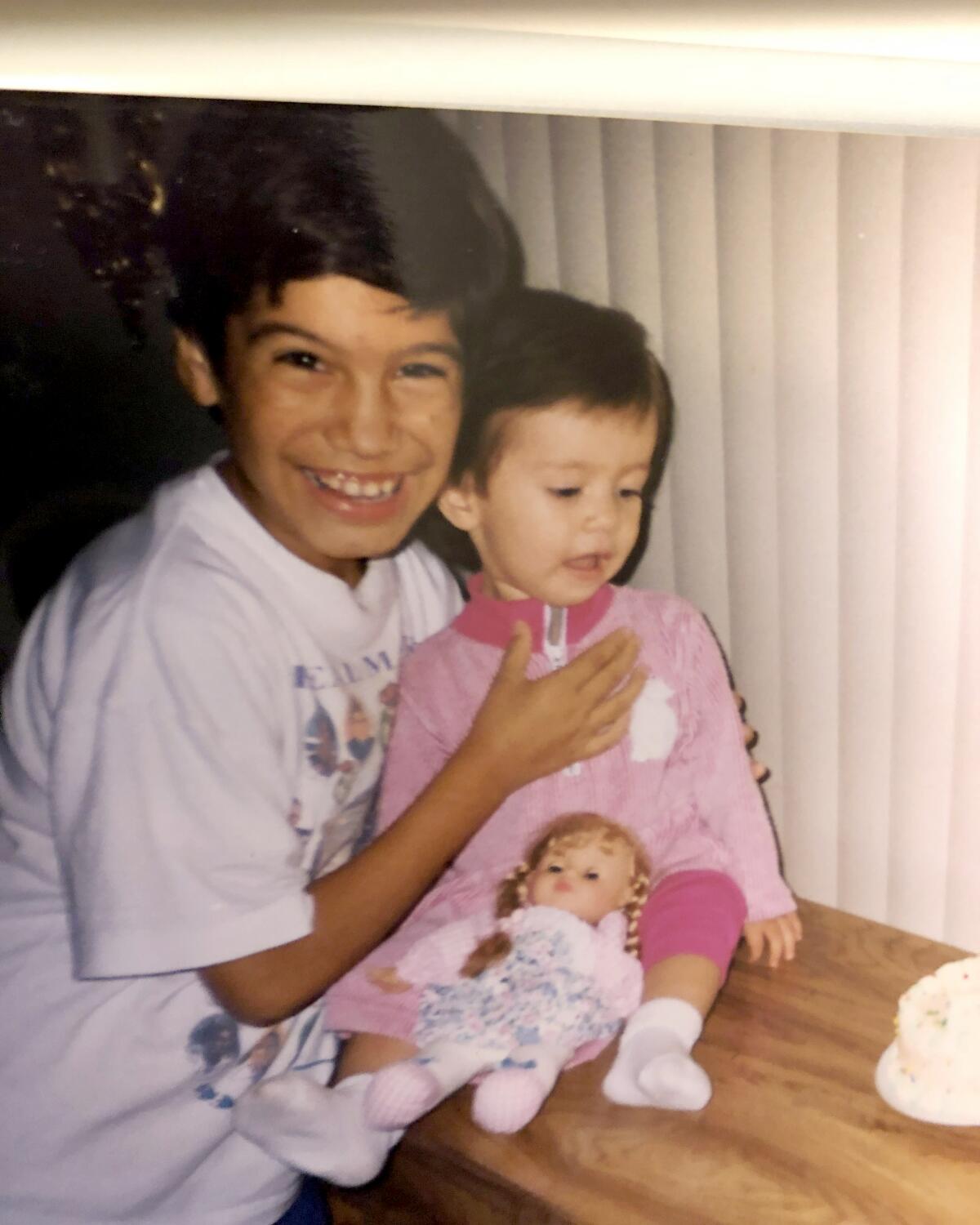 Ricardo Fernandez holds his sister Gabby Fernandez in 1998.