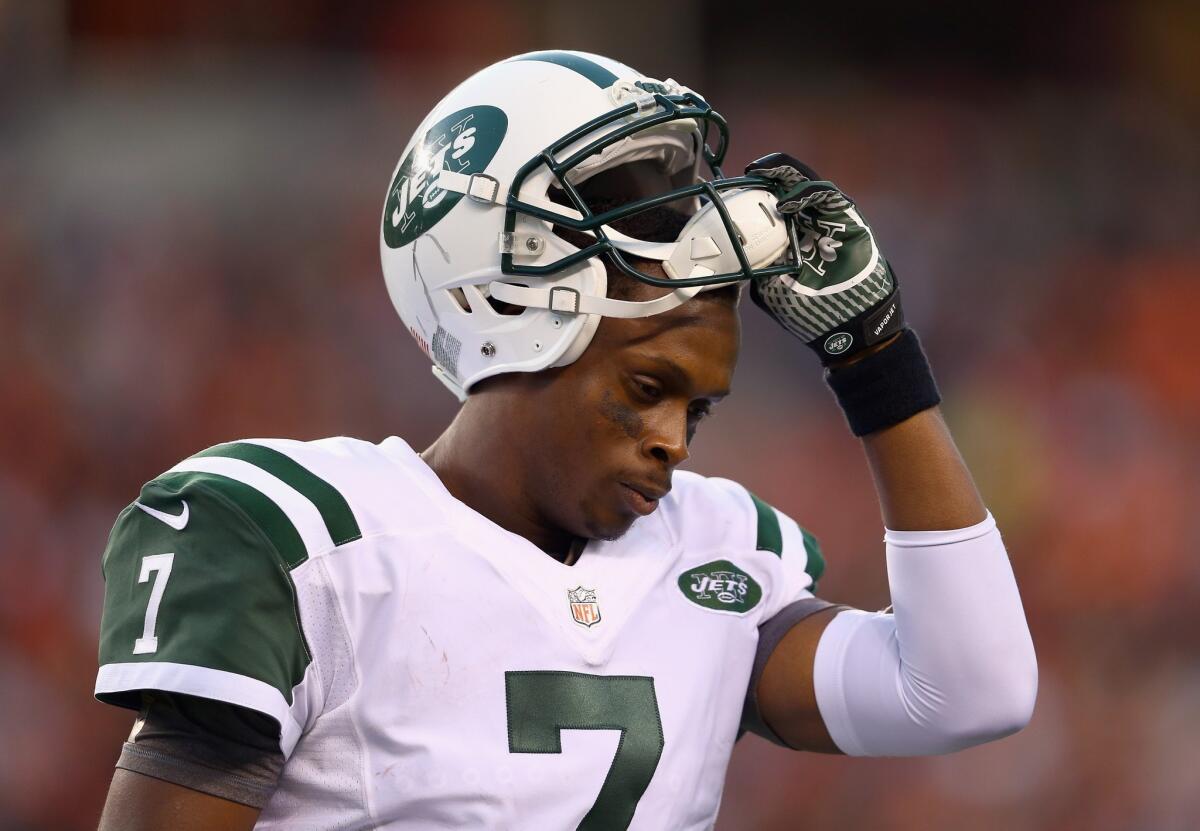 Jets quarterback Geno Smith leaves the field after having a pass intercepted and returned for a touchdown by the Bengals on Sunday.