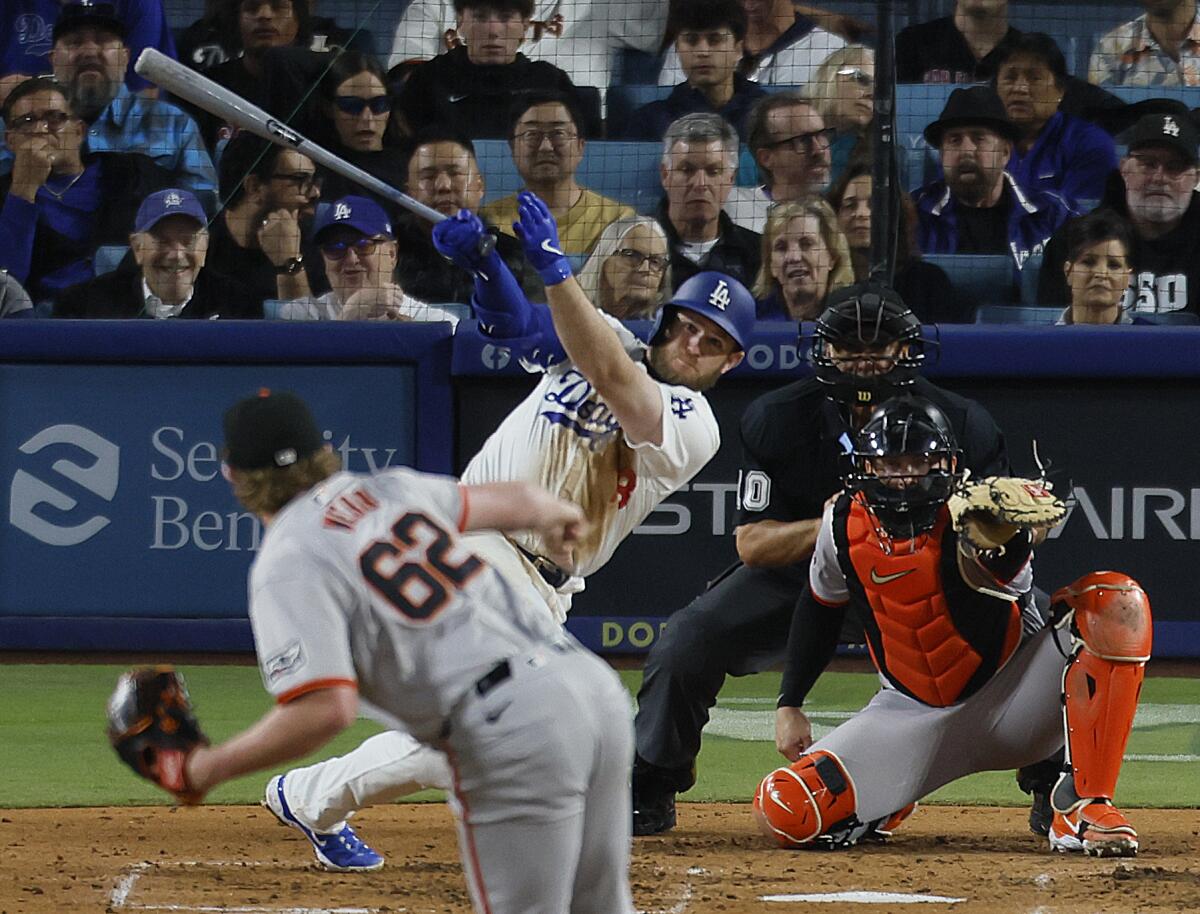 The Dodgers' Max Muncy doubles off the Giants' Logan Webb in a game at Dodger Stadium last week.