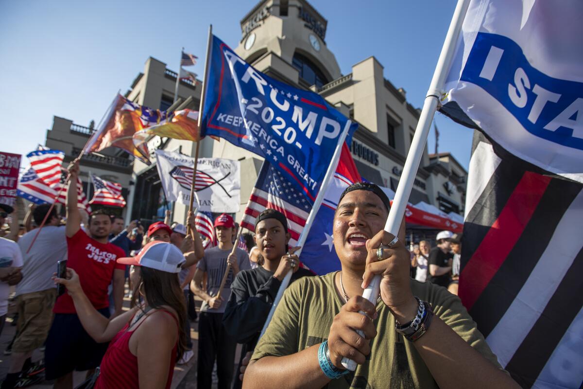 Trump supporters gather for an anti-mask "freedom march" in Huntington Beach on Monday, June 14.