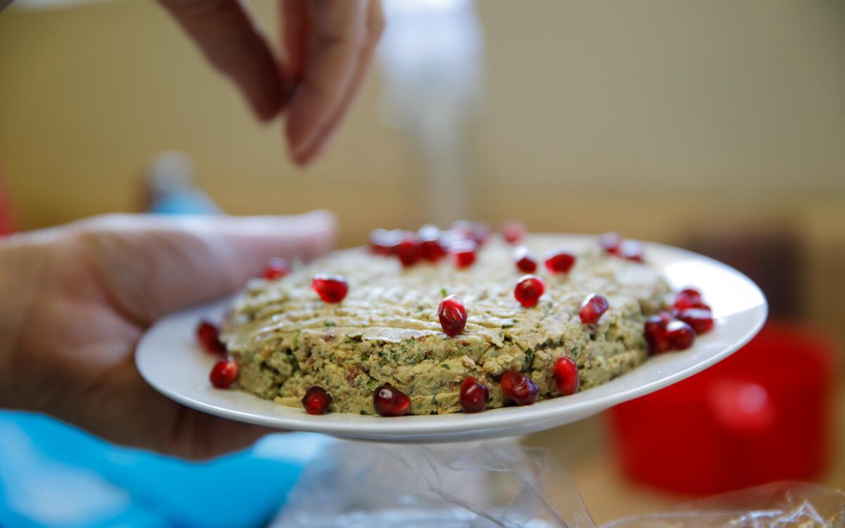 Red bean pkhali (Georgian red bean and walnut paté) garnished with pomegranate arils